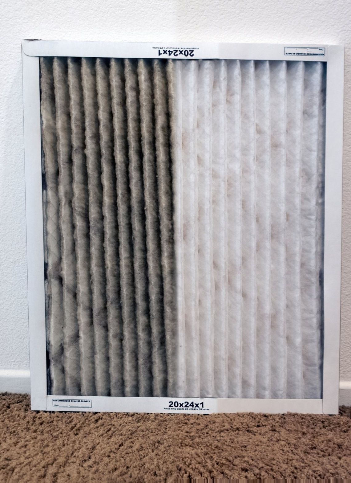 A furnace filter split down the middle: the left half, labelled Used, is clogged grey with dust; the right half, labelled New, is clean and white.